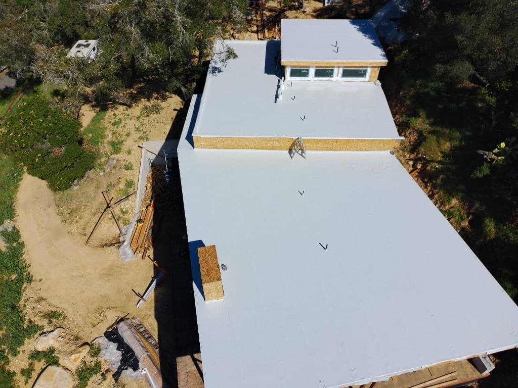 PVC roof on a Santa Barbara home with pool and landscaped backyard
